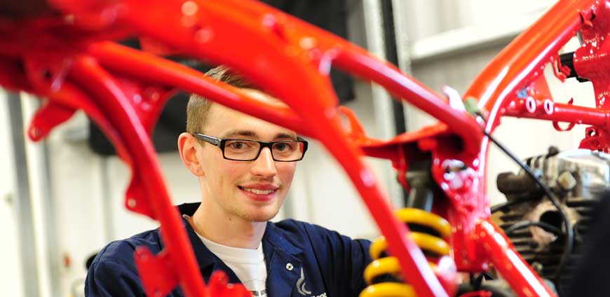 Student woeking on a car