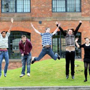 students jumping in front of roundhouse