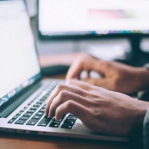 hands typing on keyboard