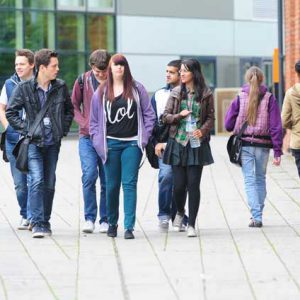 students walking in front of roundhouse