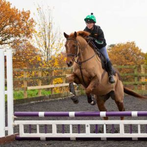 Student on horse jumping