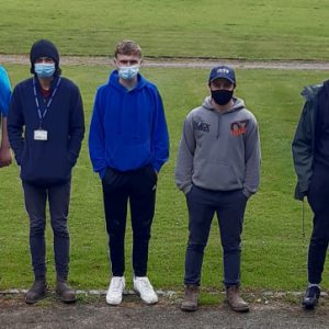 Students on grass wearing masks