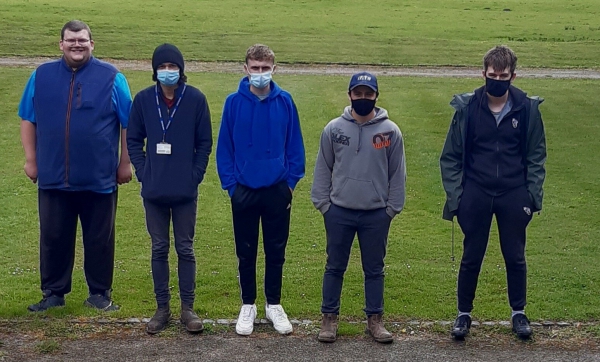 Students on grass wearing masks