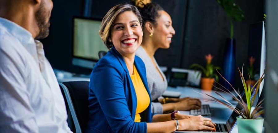 lady smiling sitting at laptop