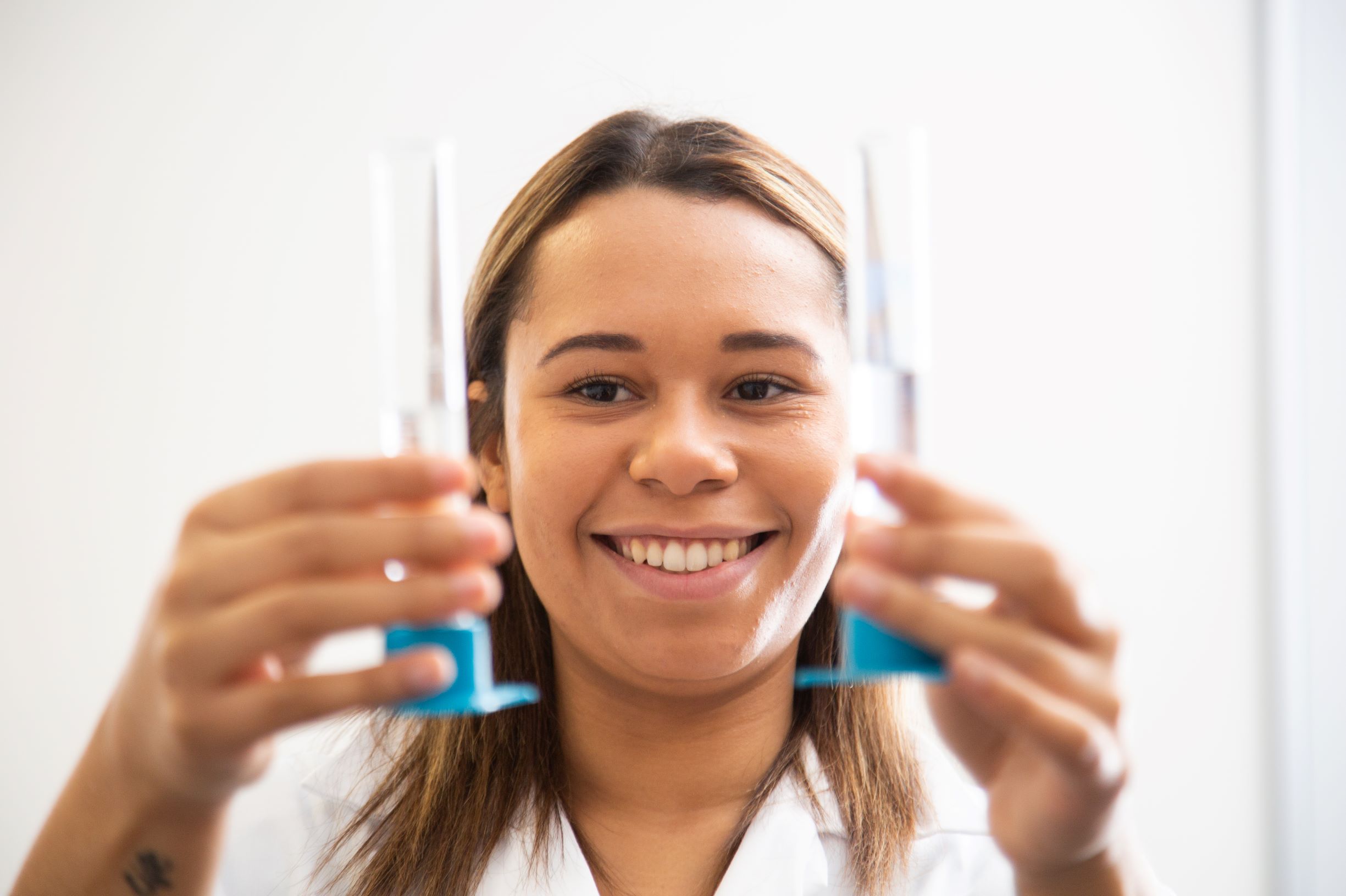 Student holding two test tubes