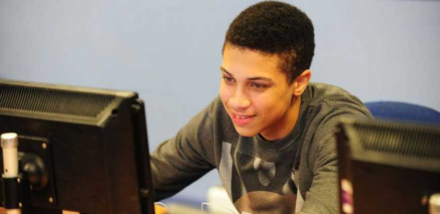 Boy working on a desktop  computer