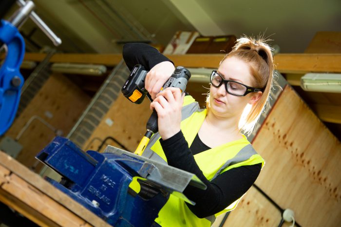 Female student using tools on her Electrical Installation course
