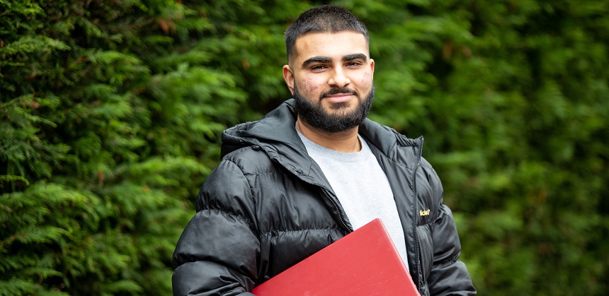 Arvin Johal holding a book
