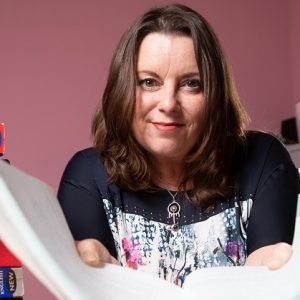 Catherine Connolly with a pile of books