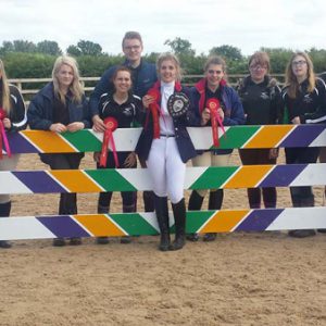 Equine students holding their medals