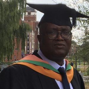 Gerald Namwaza wearing his gadtuation cap and gown