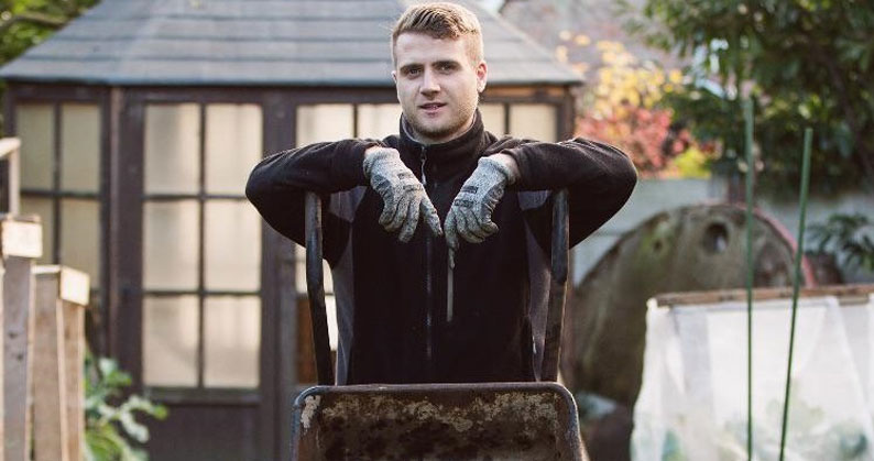 Jamie Quince-Starkey using a wheelbarrow