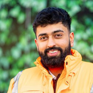 Jason Singh wearing a hi-vis vest whilst on site