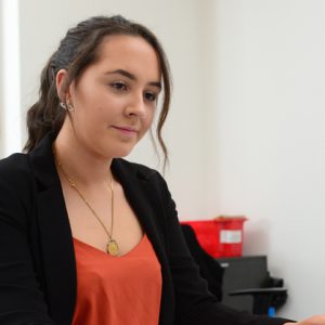 Jess Monk working in an office at Jackson Purdue Lever