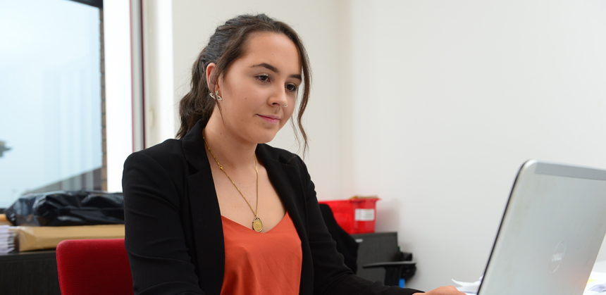 Jess Monk working in an office at Jackson Purdue Lever