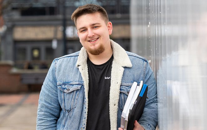 Kacper Bidniuk holding some books