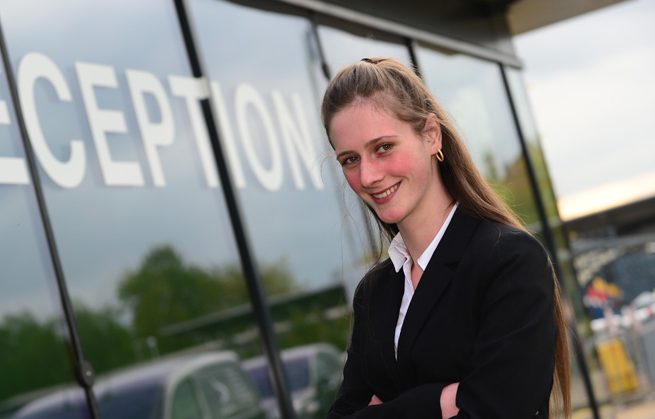 Monique stood outside of Derby College reception