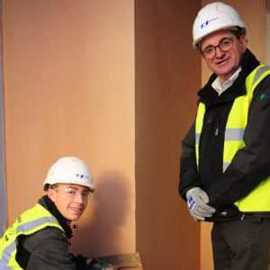 Plastering student working under supervision