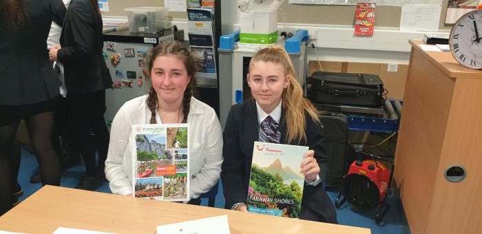 Travel & Tourism student Zoe Whitley and Mollie Chambers holding reading material from the event
