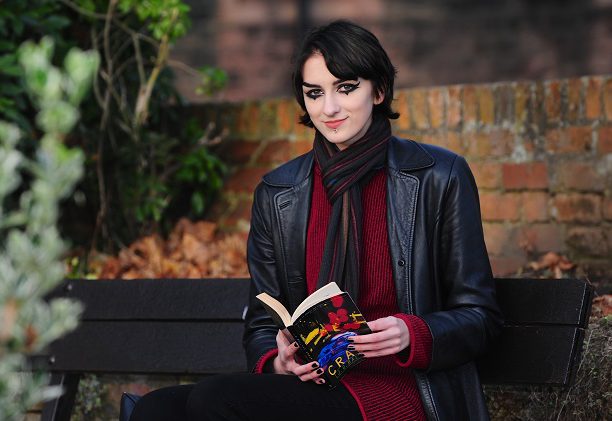 Monika Burtniece sat on a bench reading a book