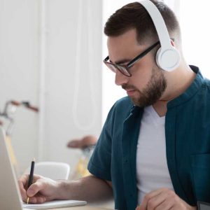 Male student working on laptop at home