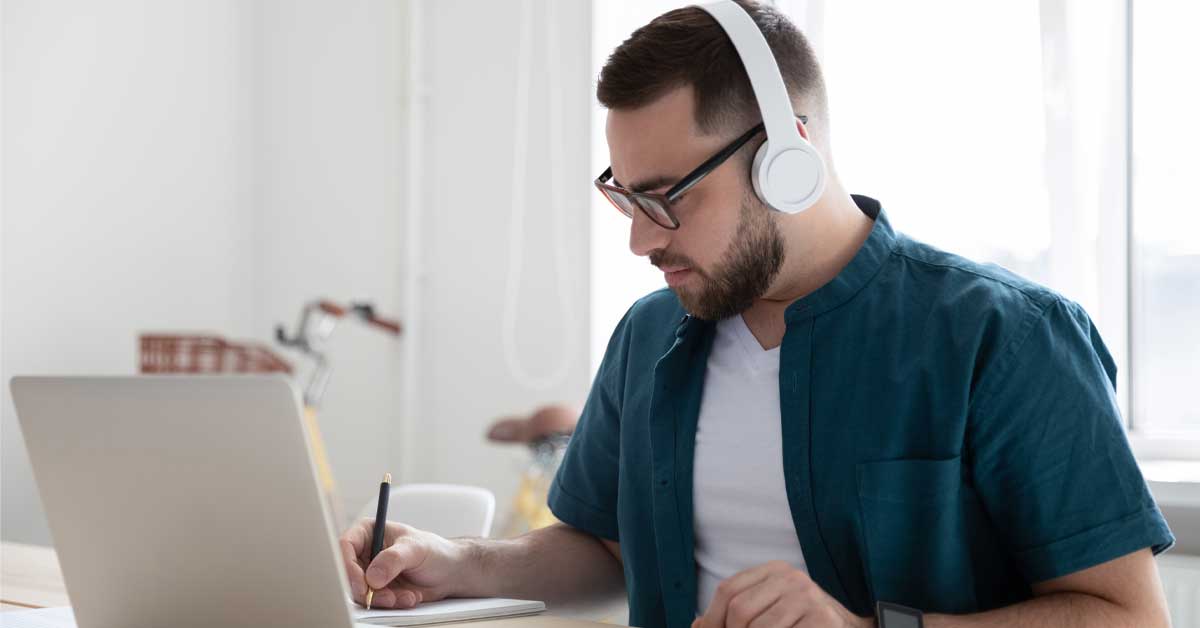 Male student working on laptop at home