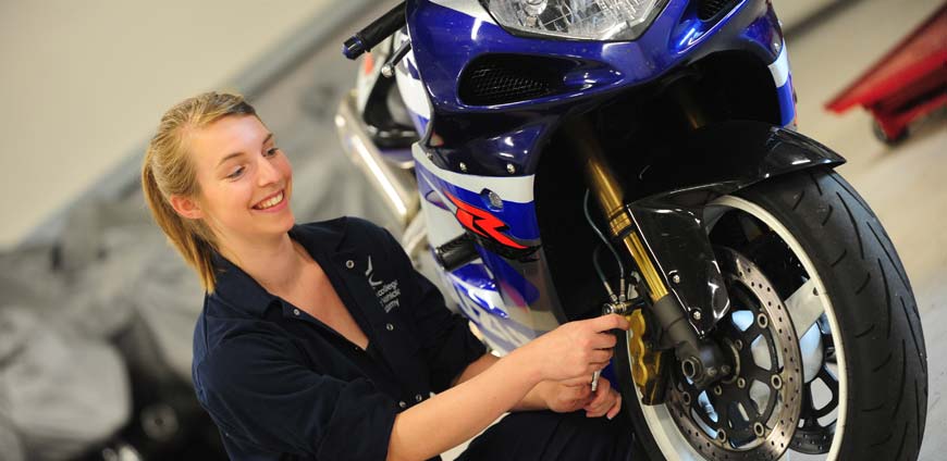 Female student working on motorbike