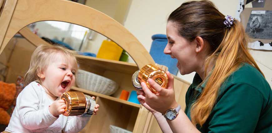 Nursery staff with child