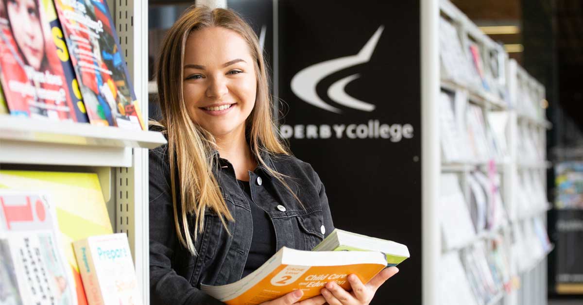 Female student reading a book in dcg library