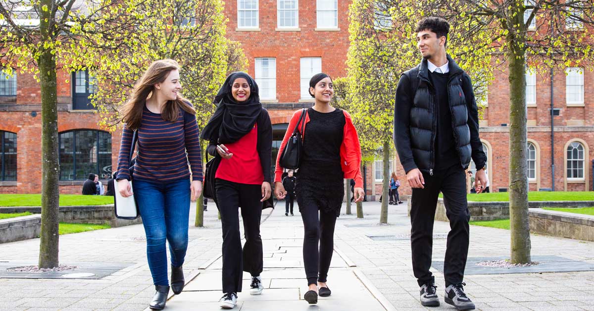 Students walking in front of the roundhouse campus