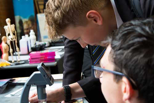 Two school students work together on desk