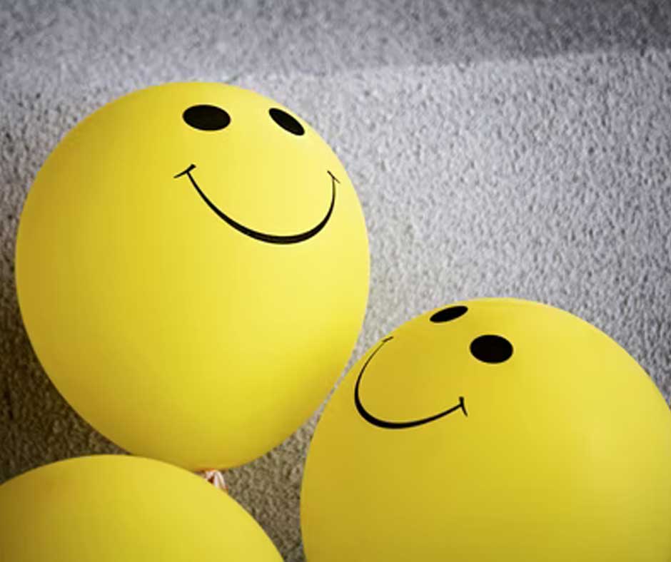 Yellow balloons with smiles on