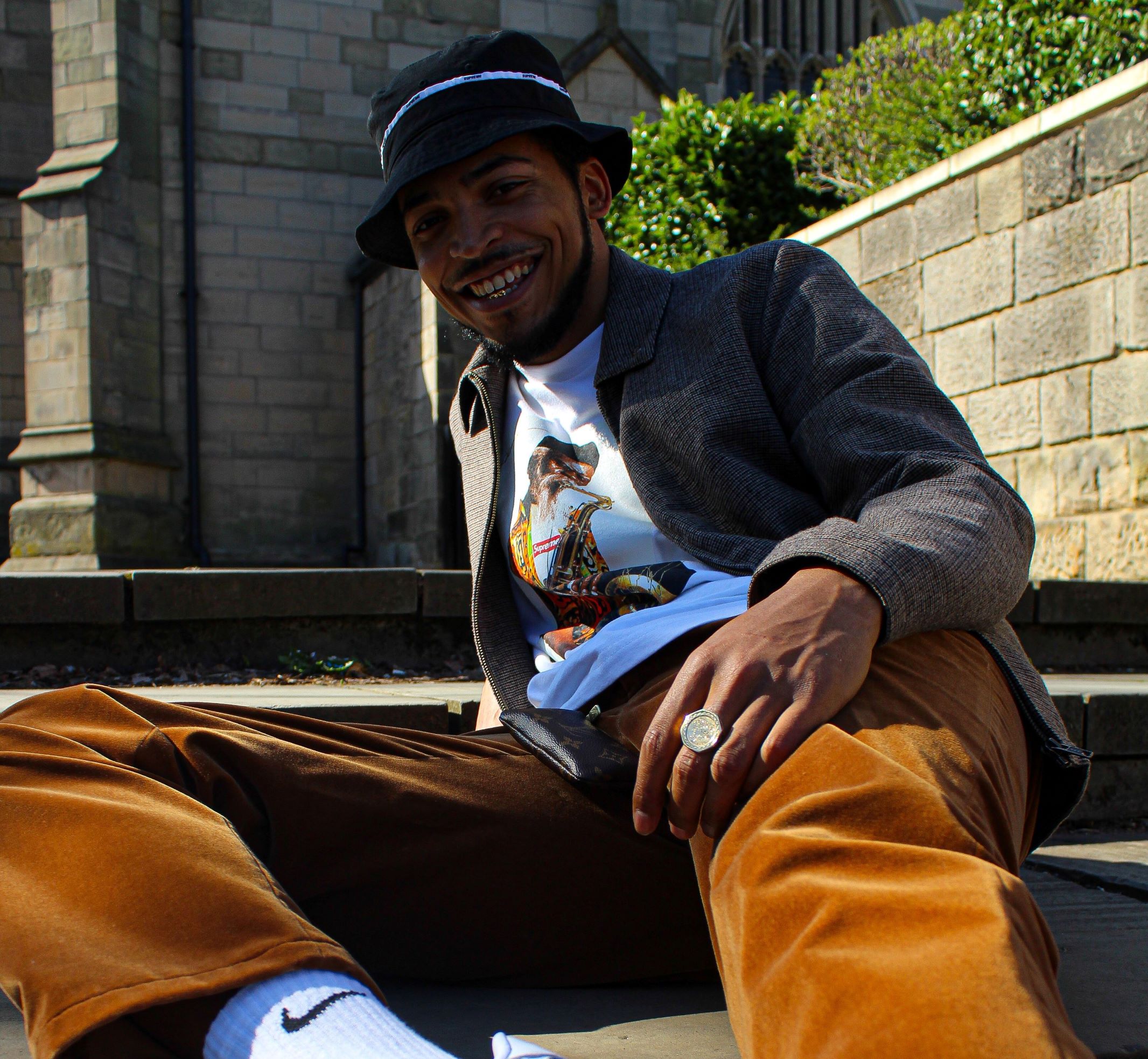 Grime rap star Eyez sat on steps outside