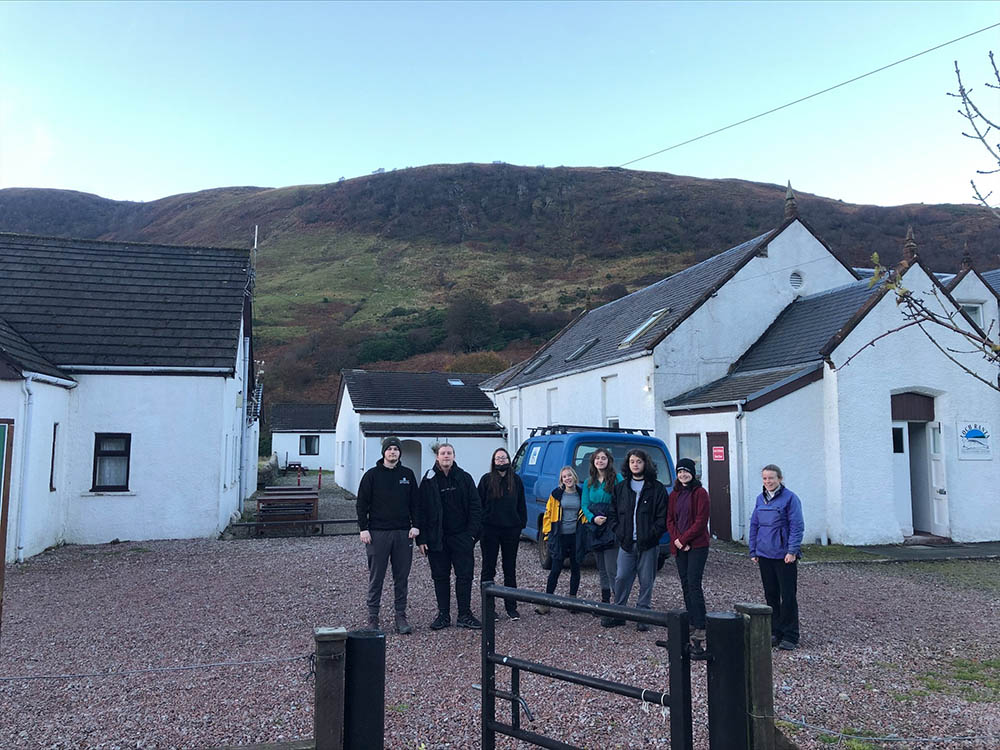 student group picture in front of water