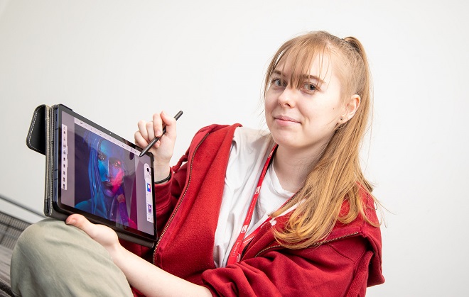 Former Games Development student Lauren Taylor using a tablet.