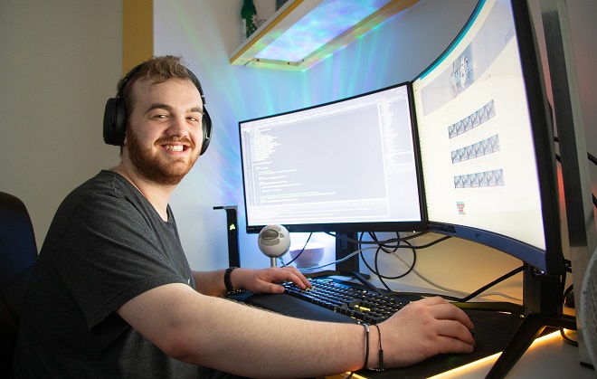 Games Design student William Hardy sat using a computer.