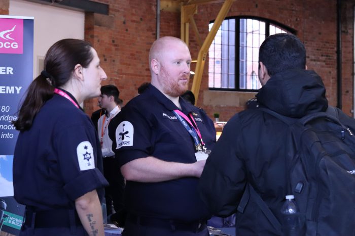 Representatives from the Royal Navy talking to students.