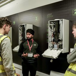 DCG Plumbing & Gas students listening to a worker from Ideal Heating.