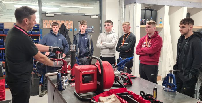 Plumbing apprentices learning from a Rothenberger employee
