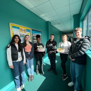 The Sugar Rush team holding their products at the Joseph Wright Centre.