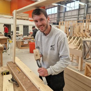 DCG Carpentry apprentice Alex Avis plaining wood at Screwfix