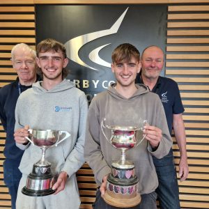 Bricklaying students Jonny and George McFarlane holding their awards stood with teachers Bill Bentley and Clive Smith.