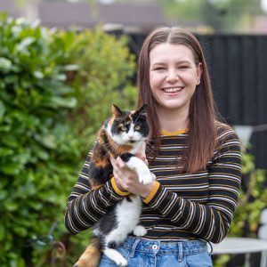 Former DCG Animal Care student Freya Munro holding her pat cat.