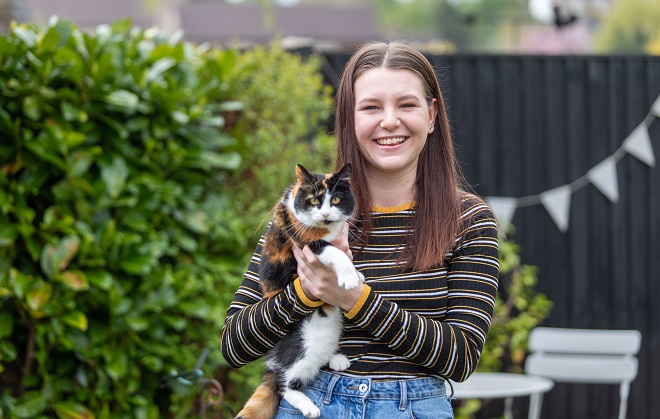 Former DCG Animal Care student Freya Munro holding her pat cat.