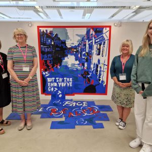 Bryan Harris Bursary award winner and Derby College Art & Design student Natalie Cooper stood with judges from Members of Art Society Derby beside her winning painting.