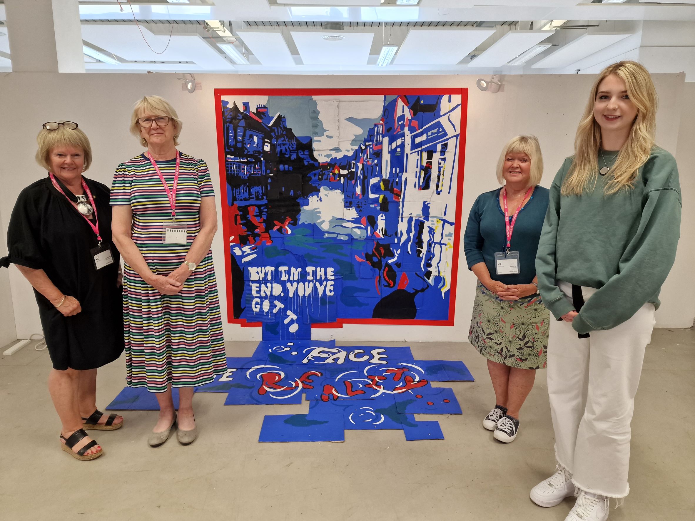 Bryan Harris Bursary award winner and Derby College Art & Design student Natalie Cooper stood with judges from Members of Art Society Derby beside her winning painting.