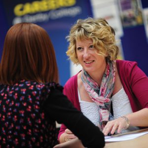 Female careers advisor talking to a student.