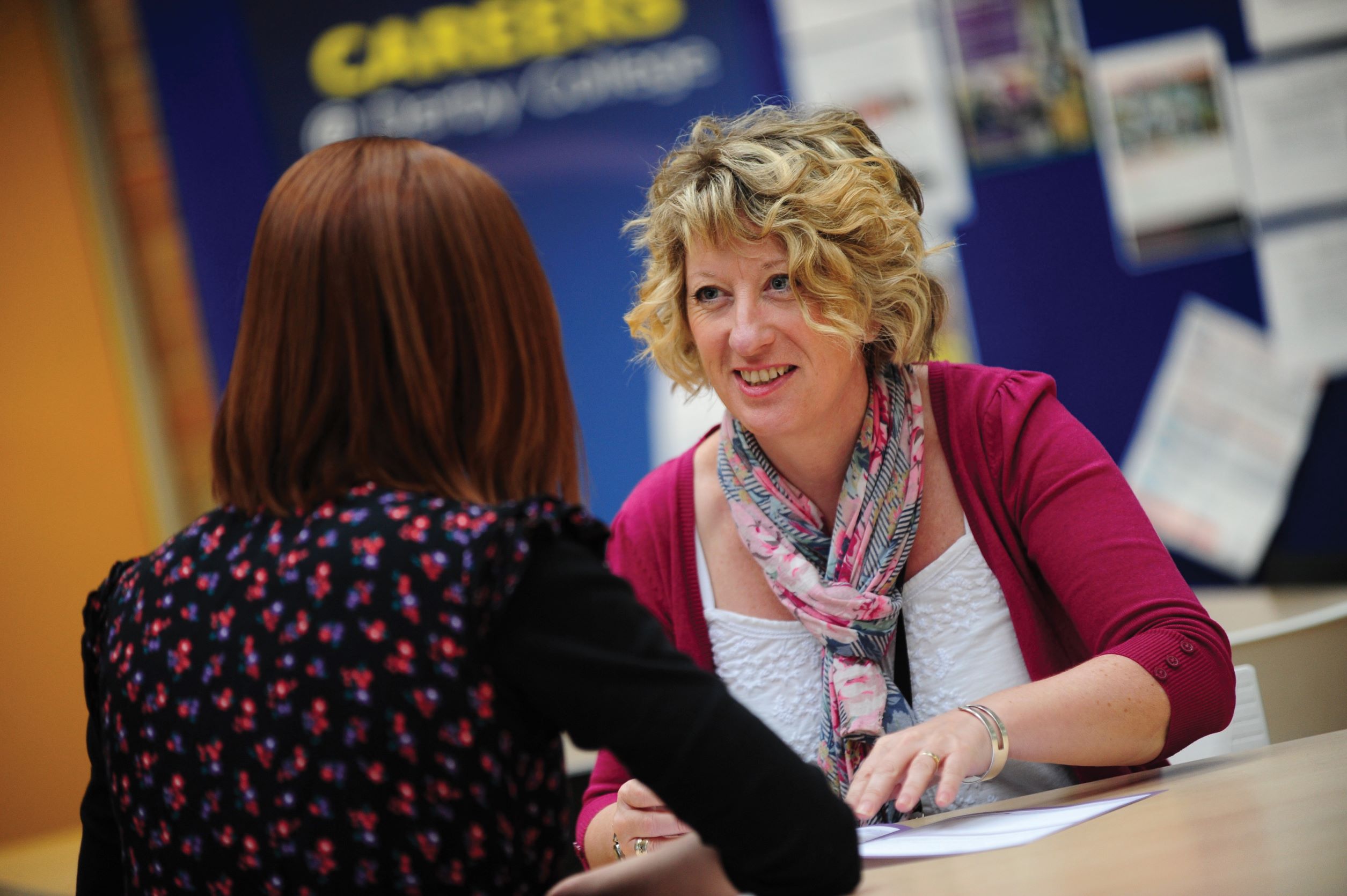 Female careers advisor talking to a student.