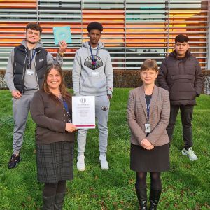 Derby College Group staff and students holding the College of Sanctuary certificate.