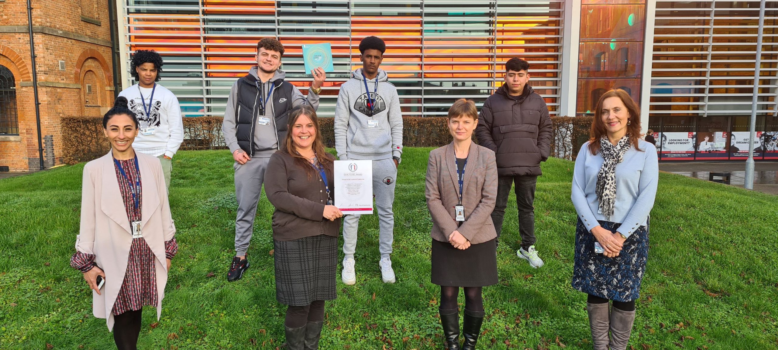 Derby College Group staff and students holding the College of Sanctuary certificate.